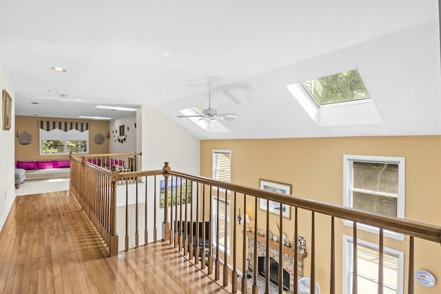 63 Forge Rd, Sharon, MA 02067 - corridor with wood-type flooring, healthy amount of natural light, a skylight, vaulted ceiling, and recessed lighting