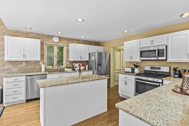 63 Forge Rd, Sharon, MA 02067 - kitchen featuring stainless steel appliances, a sink, light wood finished floors, light stone counters, and recessed lighting