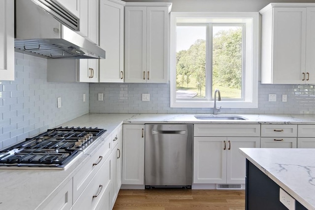 16 Pine Hill Rd Unit 16, Wenham, MA 01984 - kitchen with stainless steel appliances, exhaust hood, white cabinetry, tasteful backsplash, and light stone countertops
