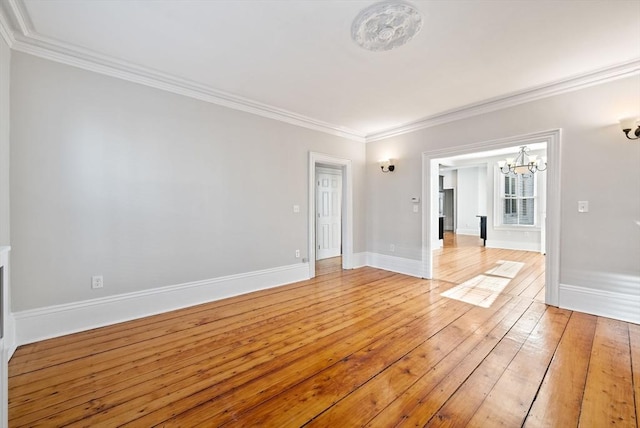 unfurnished room featuring baseboards, light wood finished floors, and ornamental molding