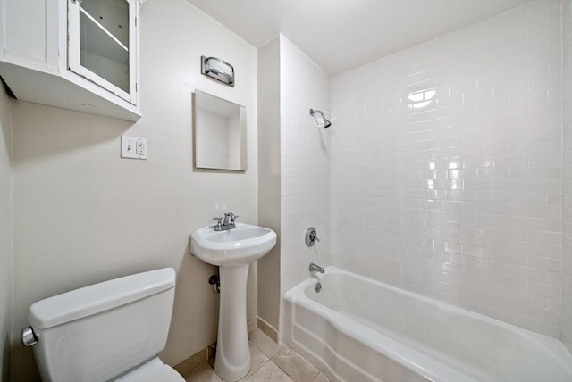 full bathroom featuring baseboards, tub / shower combination, a sink, tile patterned flooring, and toilet