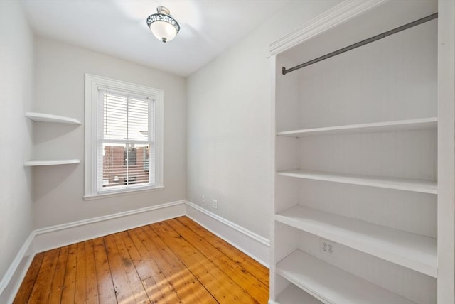 interior space with baseboards and hardwood / wood-style flooring