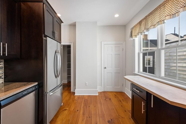 kitchen featuring baseboards, dark brown cabinetry, light wood-type flooring, recessed lighting, and stainless steel appliances