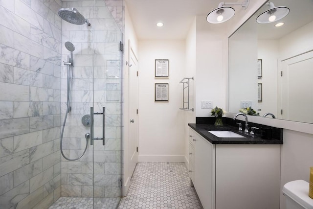 bathroom with a shower stall, vanity, baseboards, toilet, and recessed lighting