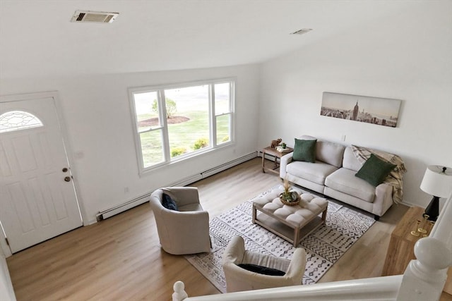 living room featuring visible vents and wood finished floors
