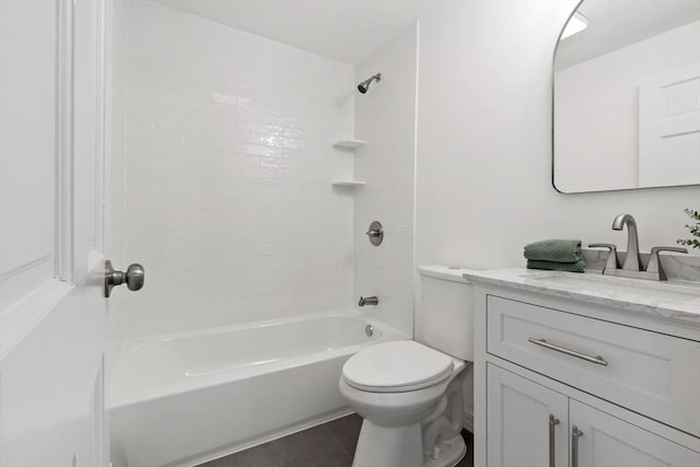 full bath featuring tile patterned floors, toilet, vanity, and washtub / shower combination