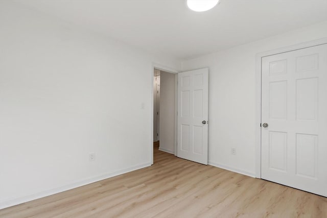 unfurnished bedroom with baseboards and wood finished floors