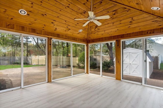 unfurnished sunroom with a ceiling fan and a healthy amount of sunlight