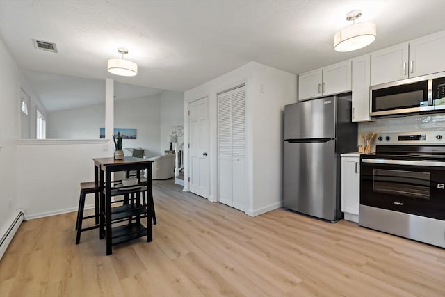 kitchen featuring white cabinets, light wood-type flooring, visible vents, baseboards, and appliances with stainless steel finishes
