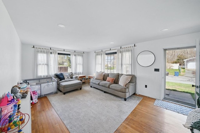 living area with light wood finished floors and recessed lighting