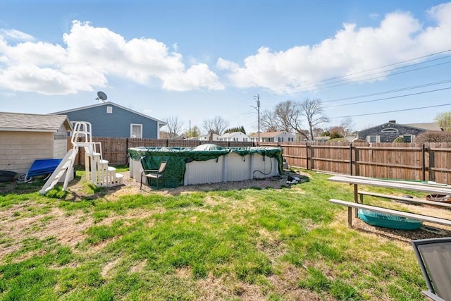 view of yard with a fenced in pool and a fenced backyard