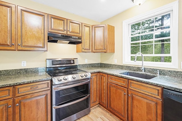 50 Maggie Ln, Southbridge, MA 01550 - kitchen with range with two ovens, a sink, black dishwasher, under cabinet range hood, and brown cabinetry