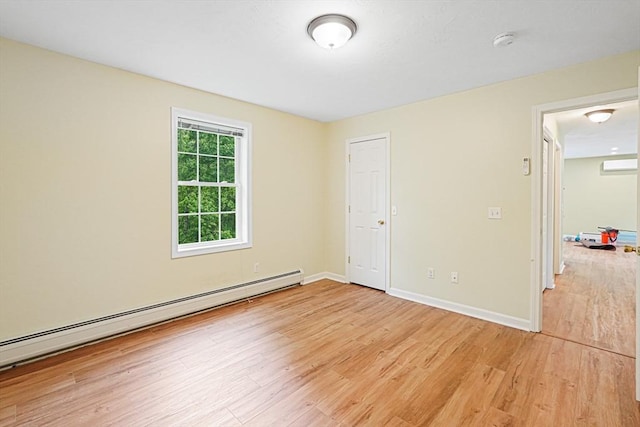 50 Maggie Ln, Southbridge, MA 01550 - unfurnished bedroom featuring a baseboard heating unit, light wood finished floors, baseboards, and an AC wall unit