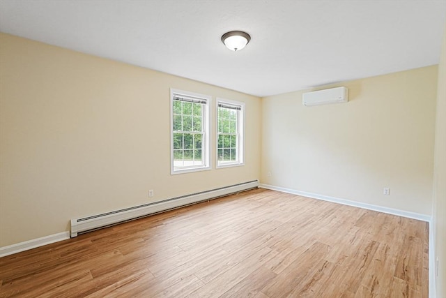 50 Maggie Ln, Southbridge, MA 01550 - empty room with a baseboard heating unit, a wall mounted AC, light wood finished floors, and baseboards