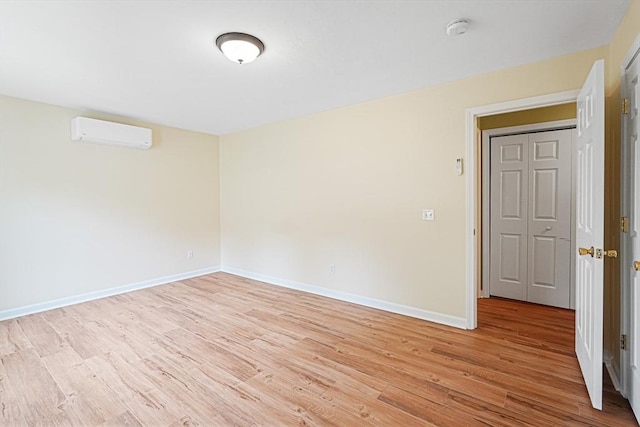50 Maggie Ln, Southbridge, MA 01550 - empty room with an AC wall unit, light wood finished floors, a smoke detector, and baseboards
