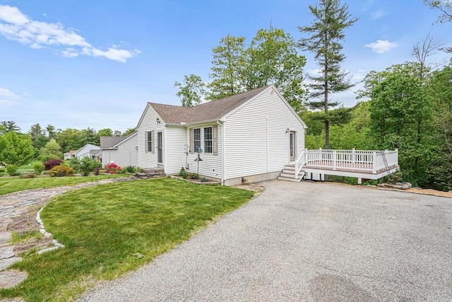 50 Maggie Ln, Southbridge, MA 01550 - view of front of home with a deck, a front yard, driveway, and a shingled roof