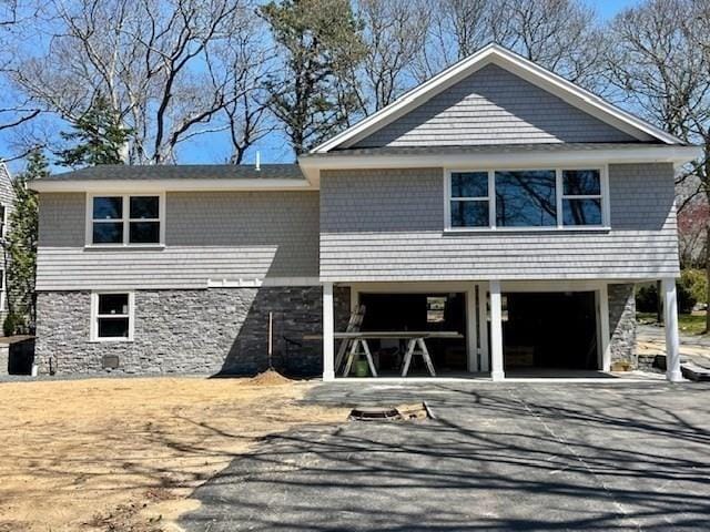 11 Madeline Rd, Falmouth, MA 02536 - view of front of home with asphalt driveway, a carport, and stone siding