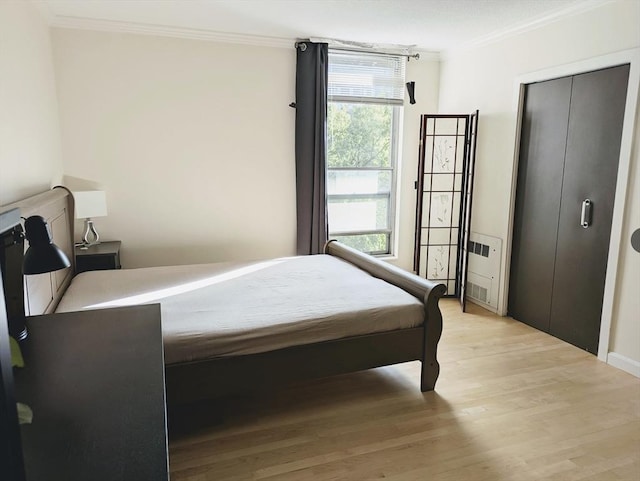 99 Pond Ave Unit 608, Brookline, MA 02445 - bedroom with crown molding, multiple windows, and light wood-style flooring