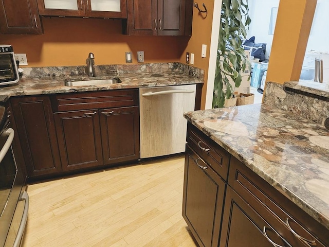 99 Pond Ave Unit 608, Brookline, MA 02445 - kitchen featuring stainless steel appliances, a sink, light stone counters, and light wood-type flooring