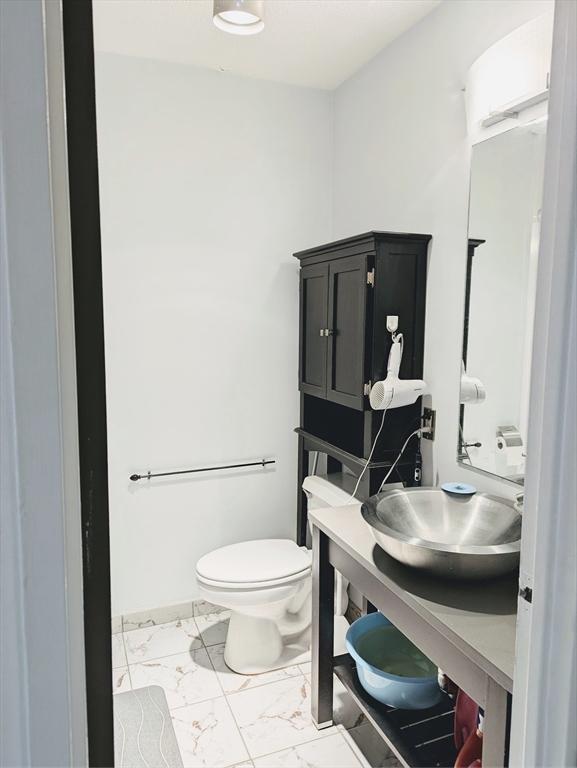 99 Pond Ave Unit 608, Brookline, MA 02445 - bathroom featuring marble finish floors, toilet, and vanity