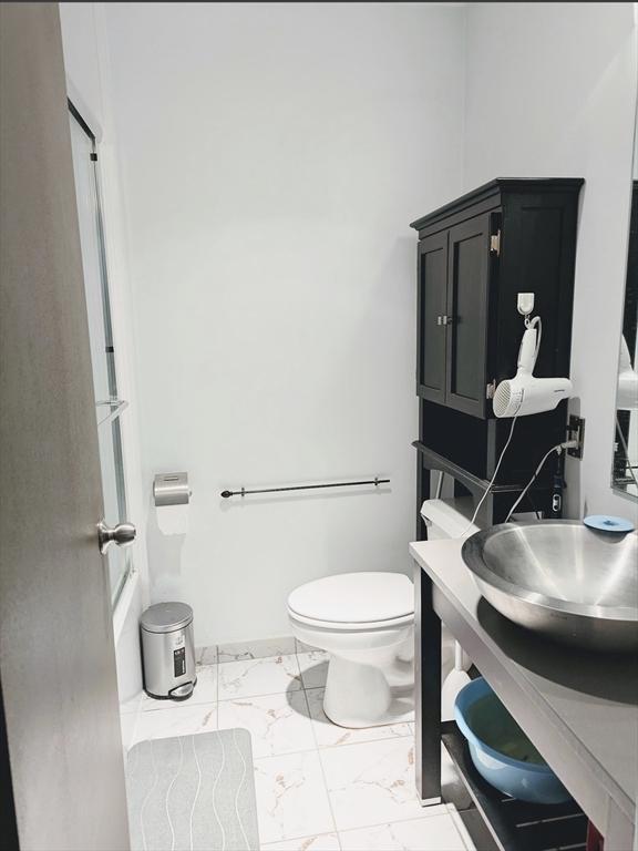 99 Pond Ave Unit 608, Brookline, MA 02445 - full bath featuring marble finish floors, toilet, and vanity