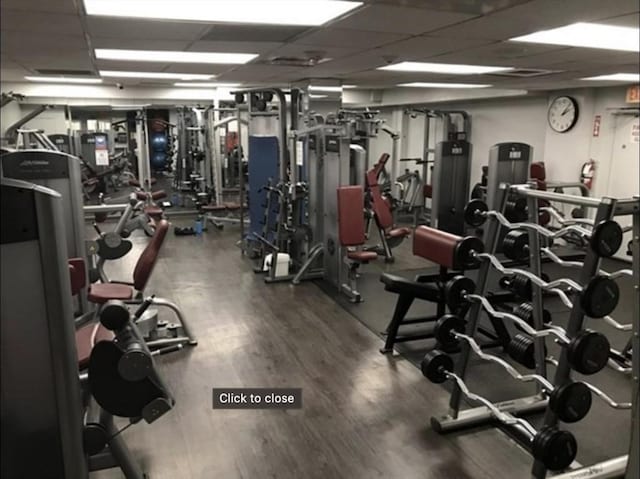 99 Pond Ave Unit 608, Brookline, MA 02445 - workout area with a paneled ceiling and wood finished floors