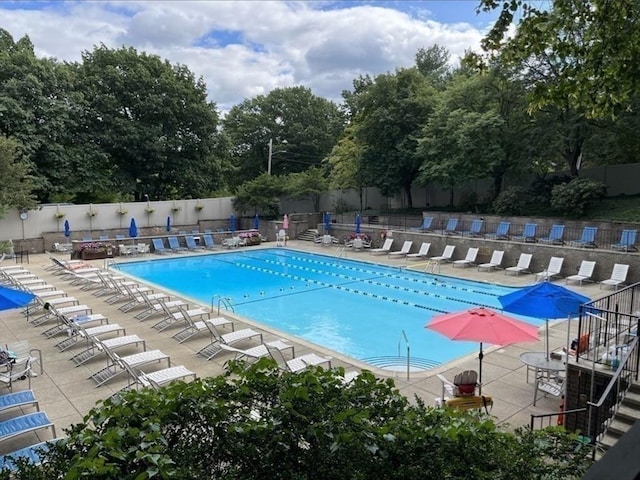 99 Pond Ave Unit 608, Brookline, MA 02445 - community pool featuring view of scattered trees and a patio area