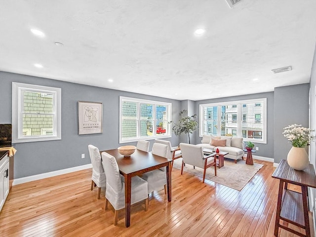 dining space with light wood-style floors, baseboards, and recessed lighting