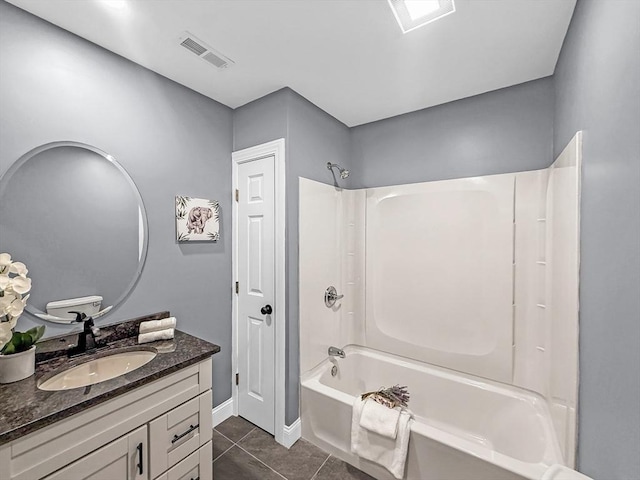 full bath with tile patterned floors, washtub / shower combination, baseboards, and vanity