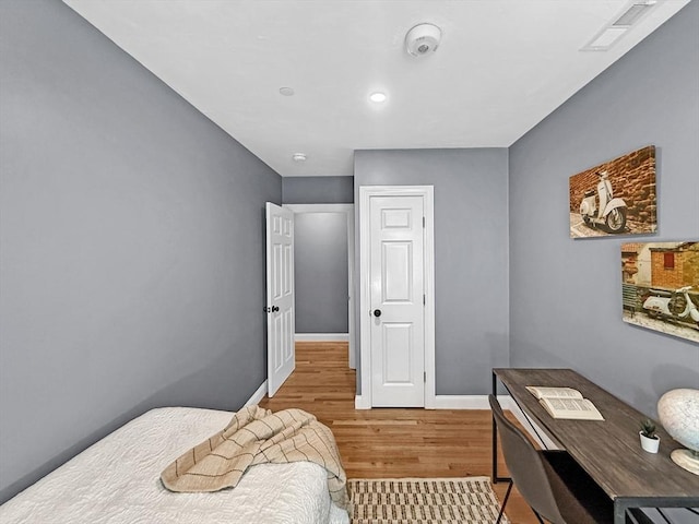 bedroom featuring wood finished floors and baseboards