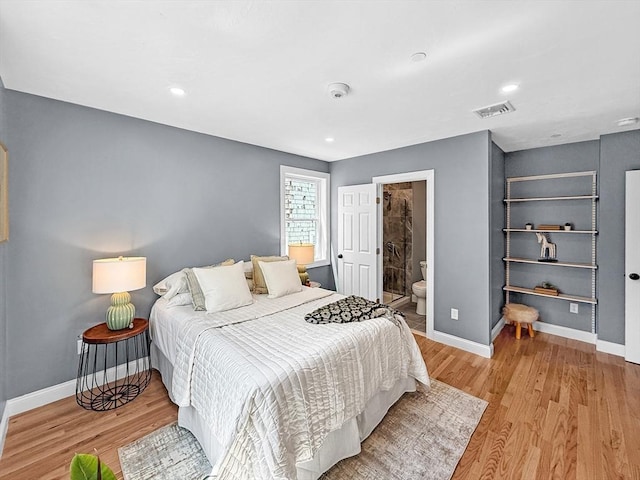 bedroom with wood finished floors, baseboards, and recessed lighting
