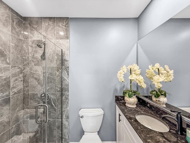 full bath with a shower stall, toilet, and vanity