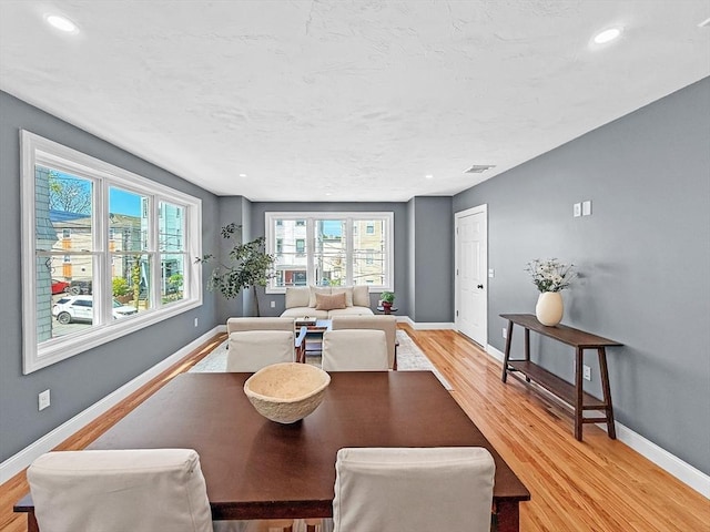 dining area with light wood-style floors, baseboards, and recessed lighting