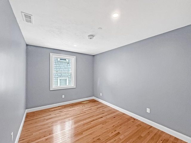 spare room with light wood-style flooring, baseboards, and recessed lighting