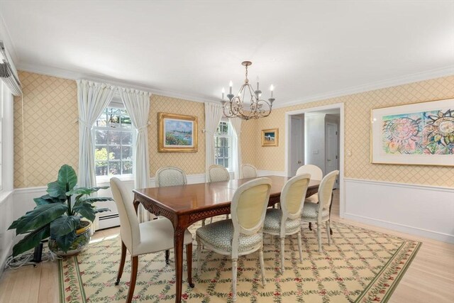 dining space with ornamental molding and wallpapered walls