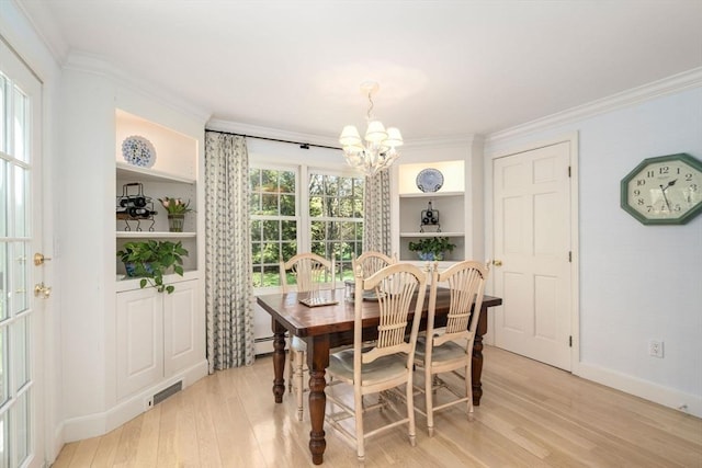 dining area with crown molding, a chandelier, light wood-style flooring, baseboards, and a baseboard heating unit