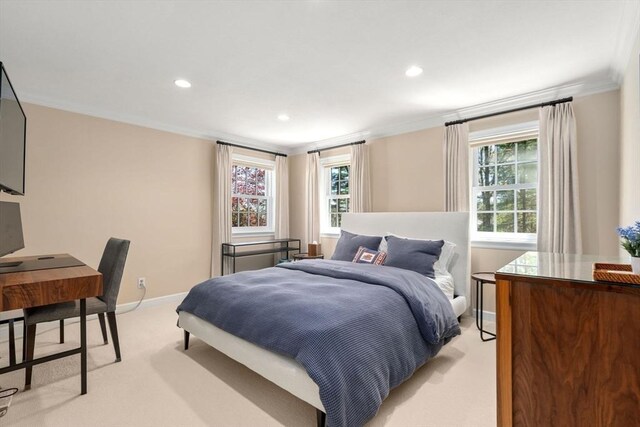 bedroom with baseboards, ornamental molding, multiple windows, and light carpet