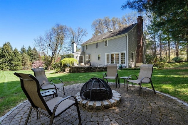 view of patio / terrace featuring french doors and a fire pit