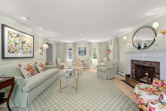 living room featuring crown molding, a baseboard radiator, a brick fireplace, and wood finished floors