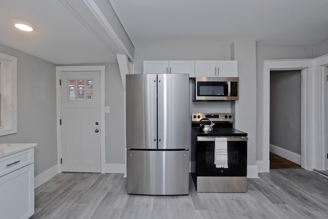 kitchen featuring white cabinetry, light hardwood / wood-style floors, and stainless steel appliances