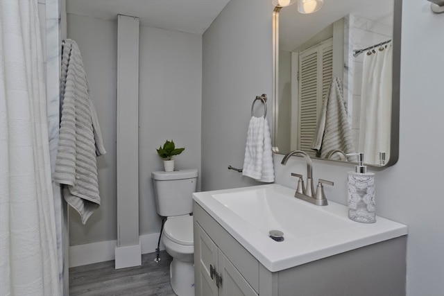 bathroom featuring hardwood / wood-style flooring, vanity, and toilet