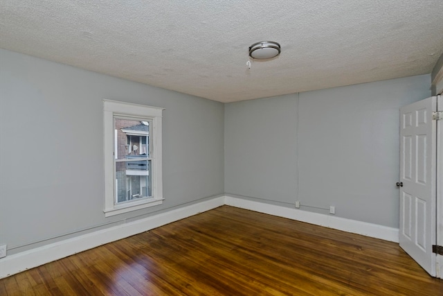 empty room featuring hardwood / wood-style floors and a textured ceiling