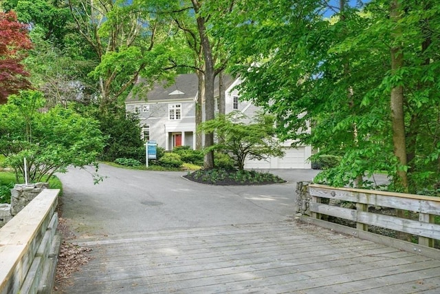 view of home's community featuring driveway and a garage