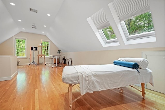 bedroom featuring light wood-style floors, recessed lighting, visible vents, and lofted ceiling with skylight