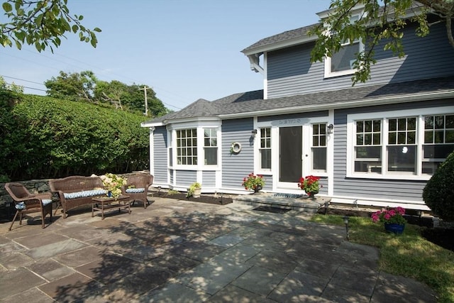 rear view of house with an outdoor hangout area and a patio