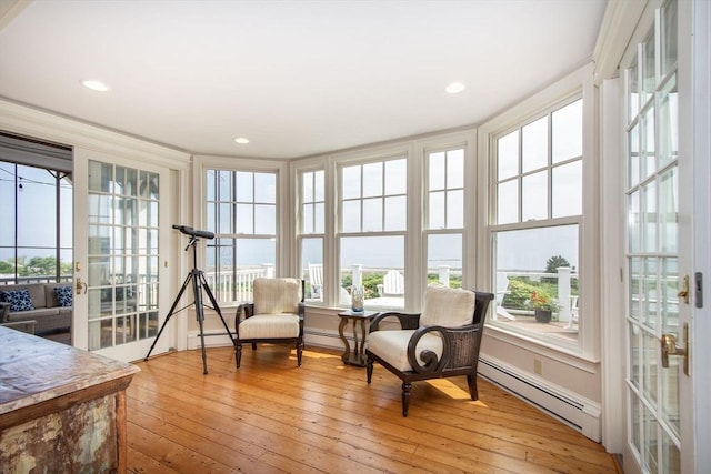 sunroom / solarium with a baseboard heating unit