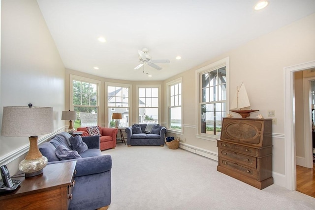 sitting room featuring a baseboard radiator, plenty of natural light, and carpet