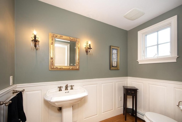 bathroom featuring a baseboard radiator and toilet