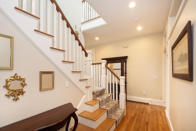 stairs with hardwood / wood-style floors