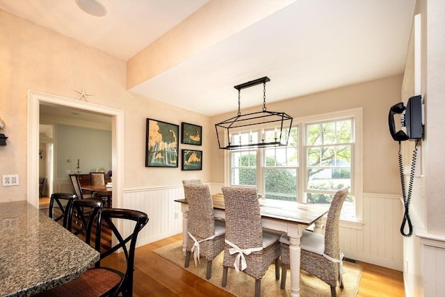 dining room featuring hardwood / wood-style floors and a chandelier